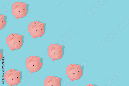 Slika na platnu Cute and modern pattern with a piggy banks on a blue background