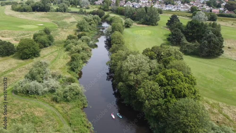 Aerial view of two paddle boarders on a river Aerial view of two paddle boarders on a river