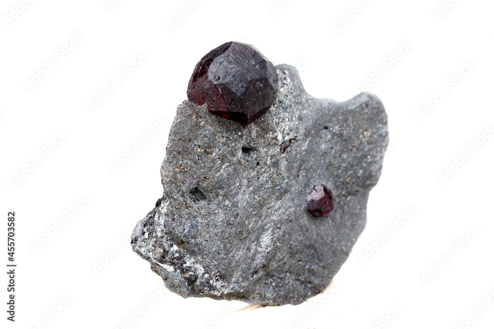 Fototapeta premium Macro mineral stone garnet in the rock on a white background