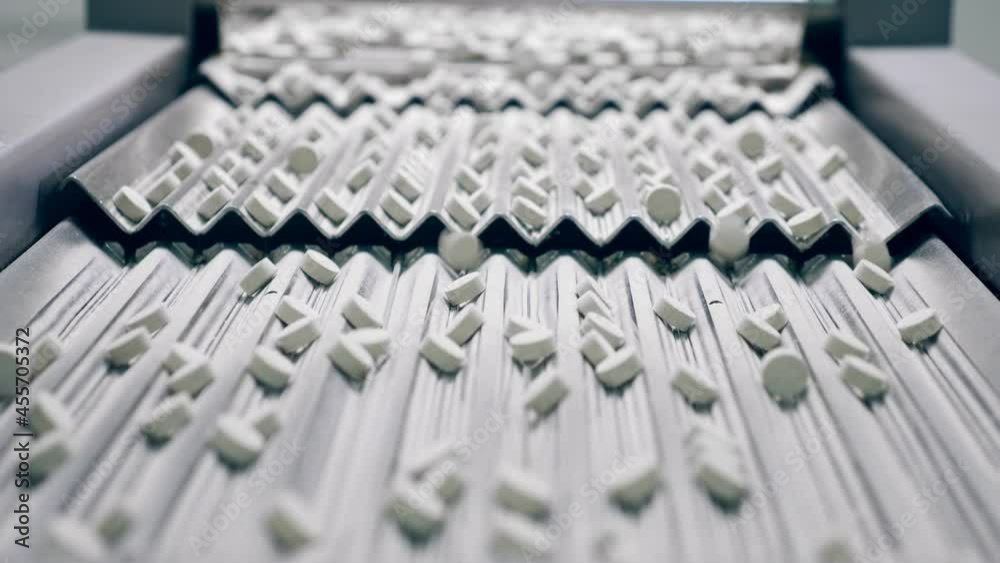 Pills are moving along the conveyor in lines Pills are moving along the conveyor in lines