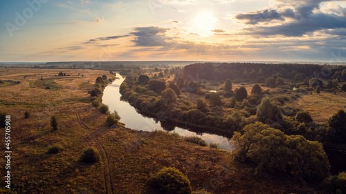Bright morning on river Snov, Chernihiv regiron, Ukraine. Drone landscape of river going in the countryside photo