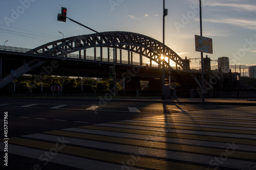 Silhouette of steel bridge. Bridge in the rays of the setting sun. Silhouette of Berezhkovsky bridge at sunset. Moscow, Russia. photo