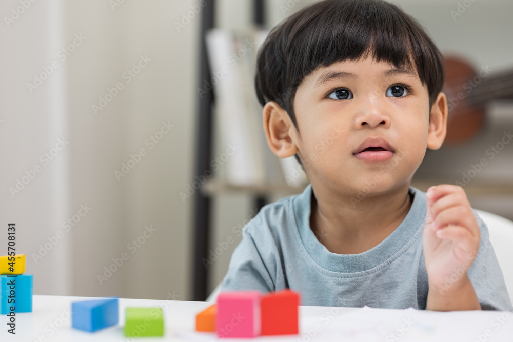 Asian little boy education from home. Developing children's learning before entering kindergarten Practice the skills of playing with wooden toys in living room. Asian little boy education from home. Developing children's learning before entering kindergarten Practice the skills of playing with wooden toys in living room.