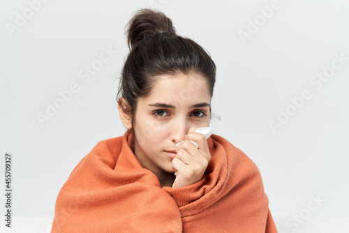 woman hiding with a blanket at home treatment cold infection