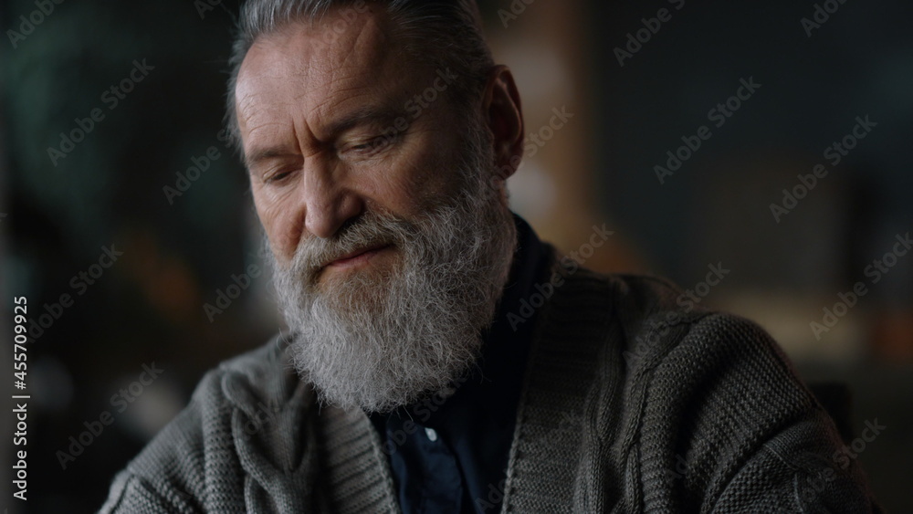 Senior man opening laptop indoors. Portrait senior businessman working at home Senior man opening laptop indoors. Portrait senior businessman working at home