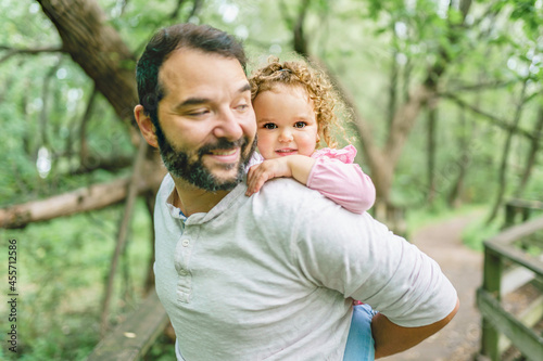 nice father having fun in summer forest with his child girl