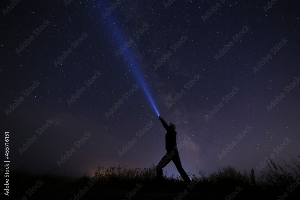 man with lantern against night sky