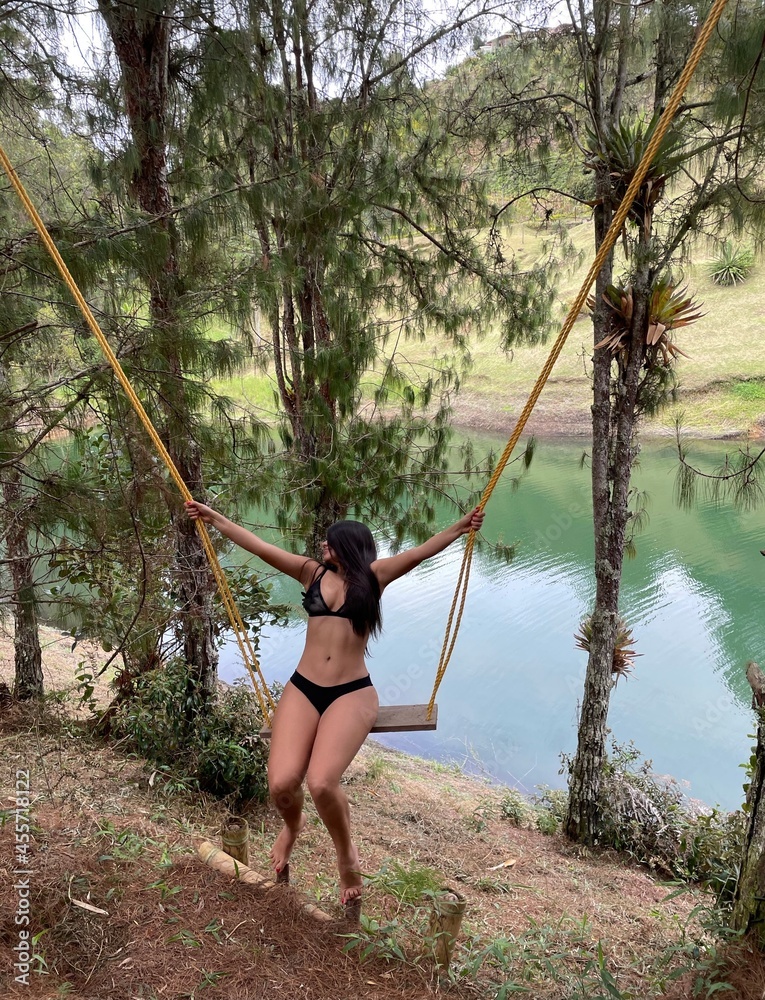 woman in bikini on a swing