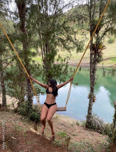 woman in bikini on a swing