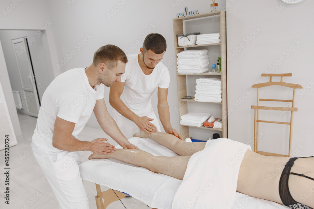 Fototapeta premium Four hands do massage to female body