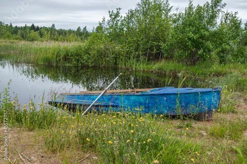 Old boat on the shore of the lake.