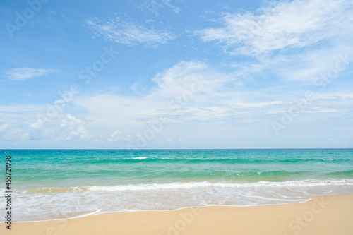 Landscape waves nature splashes beach sunlight.Blue sea waves and sky on sand famous beach.clean sea white clouds soft daylight. © loveyousomuch