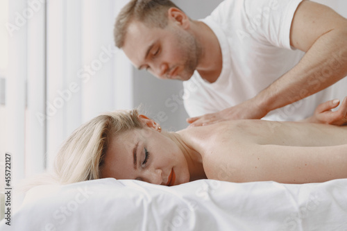 Man doctor do massage to female body