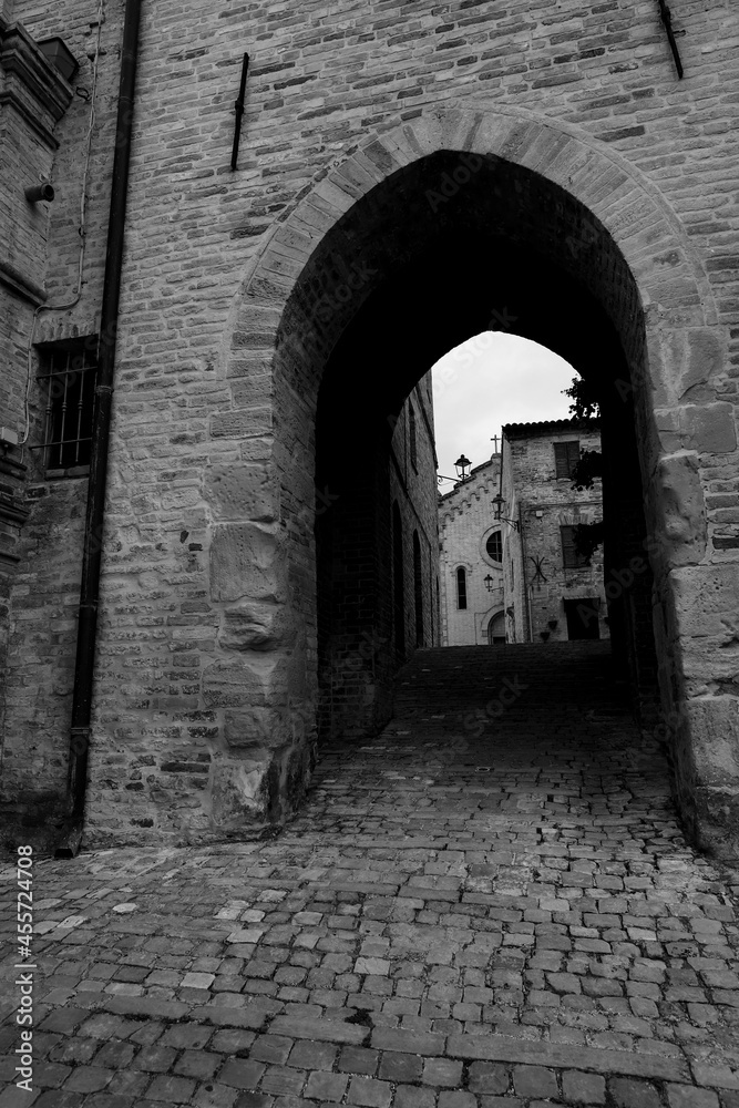 Glimpse of a small medieval village in the province of Fermo, in the background the Marche countryside, very cloudy sky, black and white photo. Glimpse of a small medieval village in the province of Fermo, in the background the Marche countryside, very cloudy sky, black and white photo.