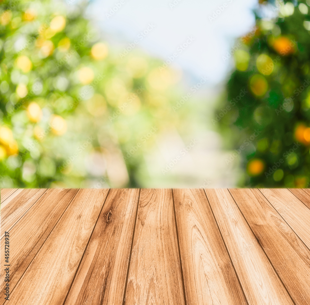 Empty wood table with free space over orange trees, orange field background. For product display montage Empty wood table with free space over orange trees, orange field background. For product display montage