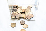 scattering of coins on a white background close-up, piggy bank change