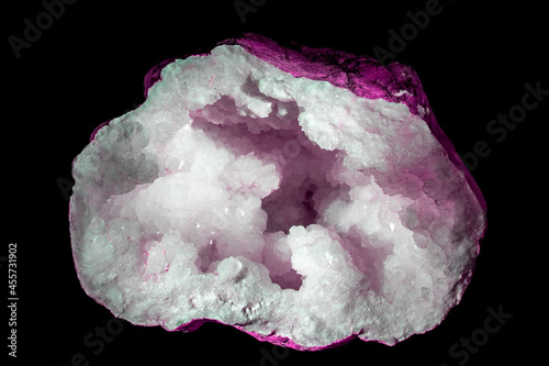 Pink quartz crystal geode isolated on black background