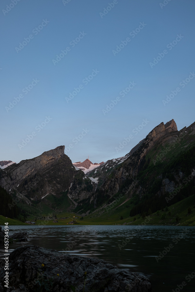 Wonderful view at an alpine lake in Switzerland in the blue hour. Amazing morning view before the sun comes up. Epic scenery at one of the most beautiful place in the world.