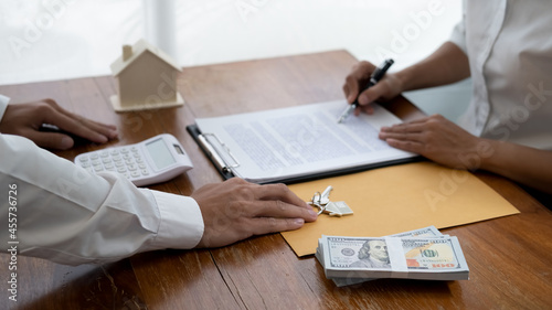 Real estate agent and customer signing contract to buy house, insurance or loan real estate.