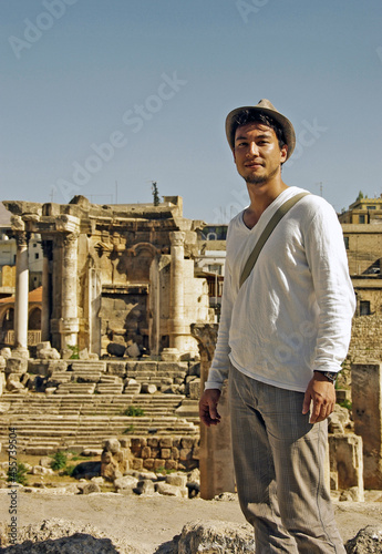 Man standing beside an ancient ruins