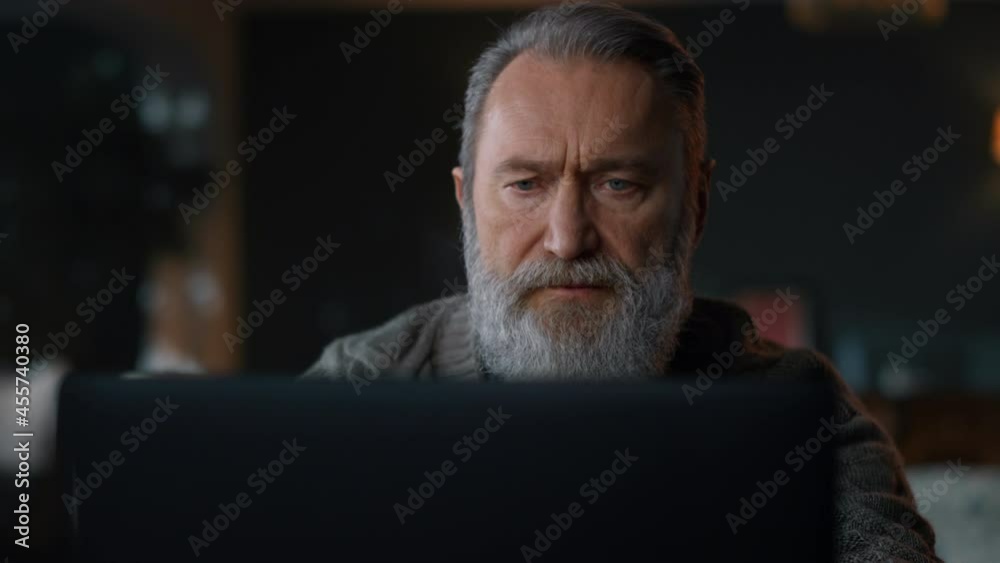 Senior man working computer cabinet. Old businessman using laptop home. Senior man working computer cabinet. Old businessman using laptop home.