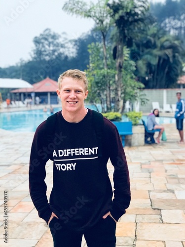 Portrait of smiling man standing near pool photo