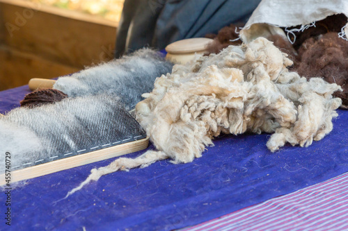 comb and wool of sheep cardin traditional production of merino yarn photo