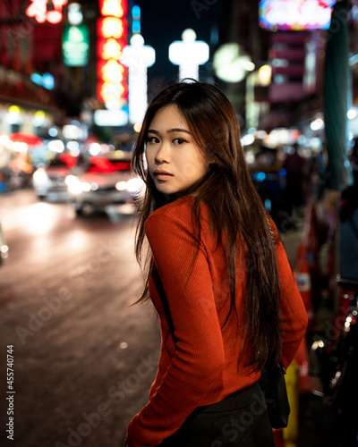 Portrait of Woman standing in a city during night time