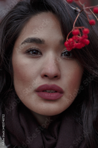 Portrait of woman near red flower photo