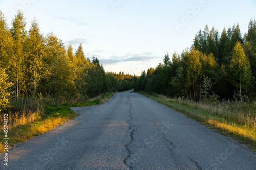 Empty autumn road in Finland during sunset