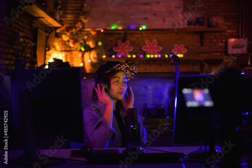 Woman surrounded by cameras and microphone in a podcast studio