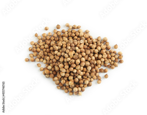 Heap of dried coriander seeds on white background, top view
