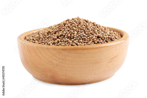 Dried coriander seeds in wooden bowl on white background