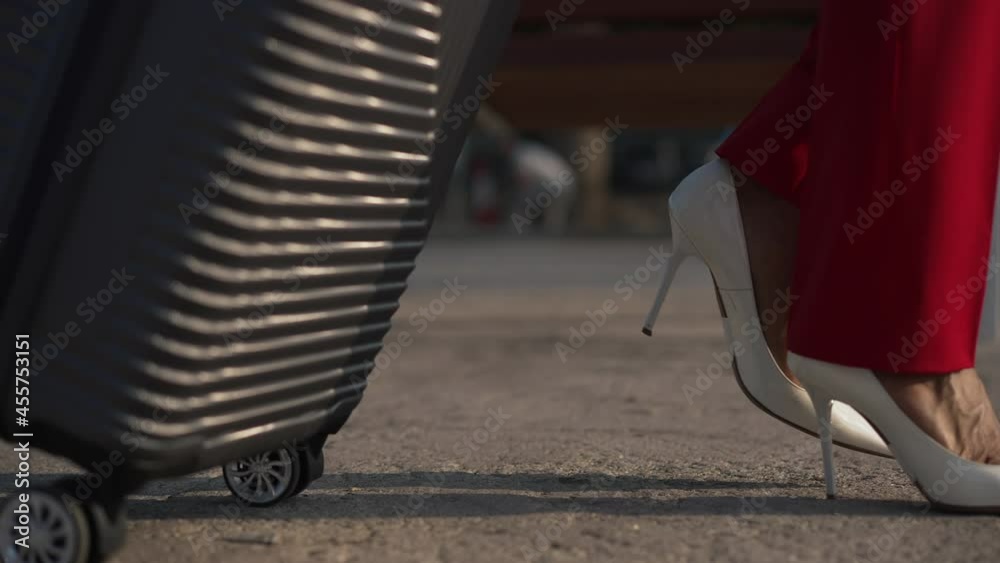 Live camera follows female legs in red pants and white highheels