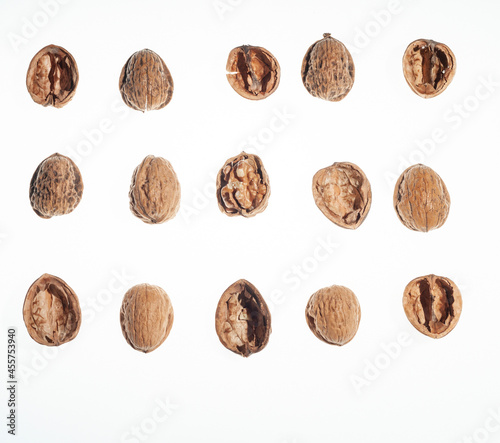 Top view of three rows and five columns of walnuts or parts of walnut shells