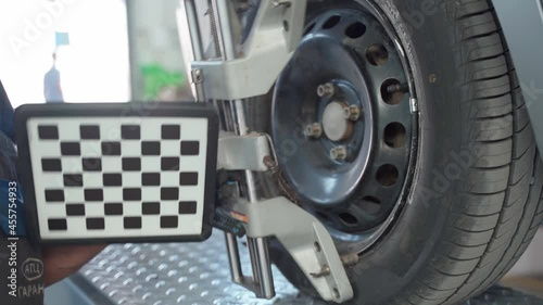 The mechanic installs the panel on the wheel to adjust the camber