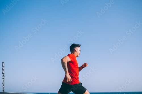 Young sportsman running in open air