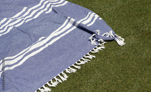 detail of a beach towel on pool lawn