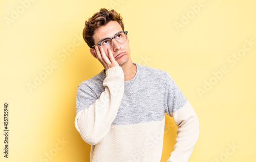 Obraz na płótnie young teenager boy feeling bored, frustrated and sleepy after a tiresome, dull a