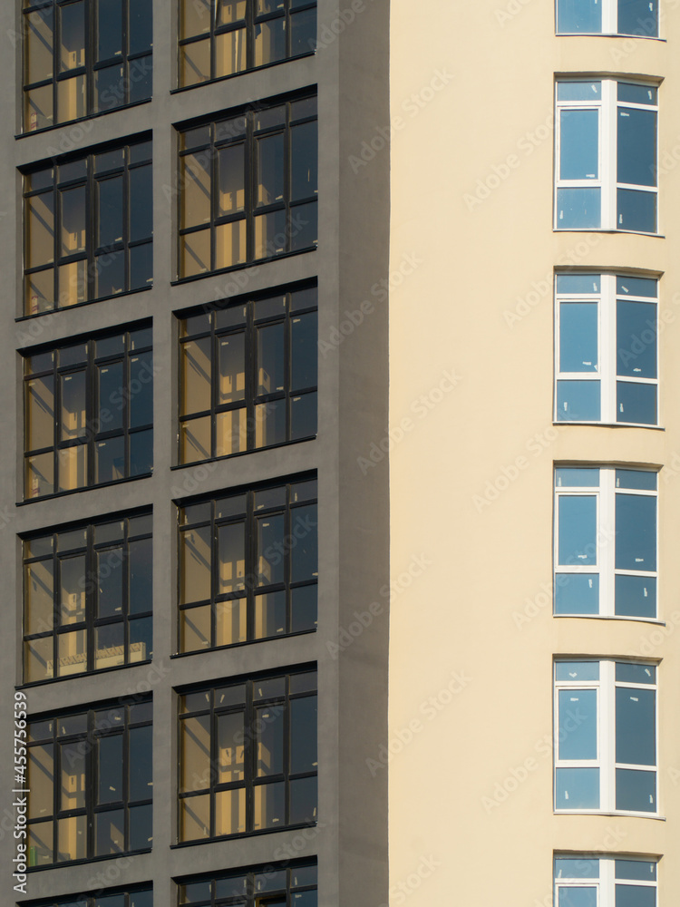 windows of a new brown multi-storey building in sunny summer weather