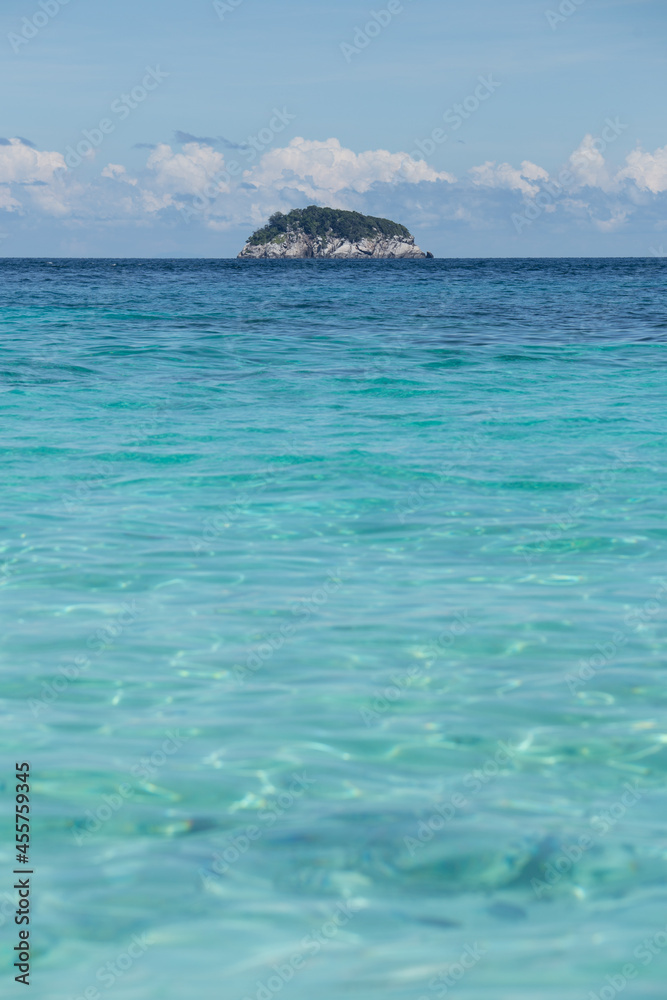 Rippling sea with rocky hill on horizon Rippling sea with rocky hill on horizon