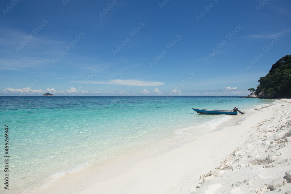 Wet sandy beach with boat washed by turquoise sea Wet sandy beach with boat washed by turquoise sea