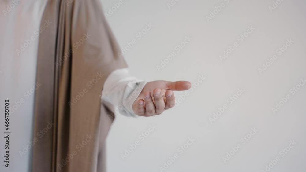 Jesus hand in a robe on a white background. Studio. High quality 4k footage