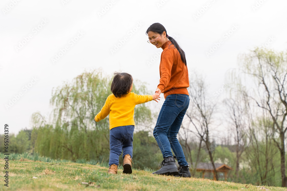 lovely asian baby girl running on the lawn lovely asian baby girl running on the lawn