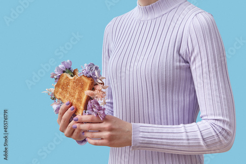 Woman with bitten flower sandwich