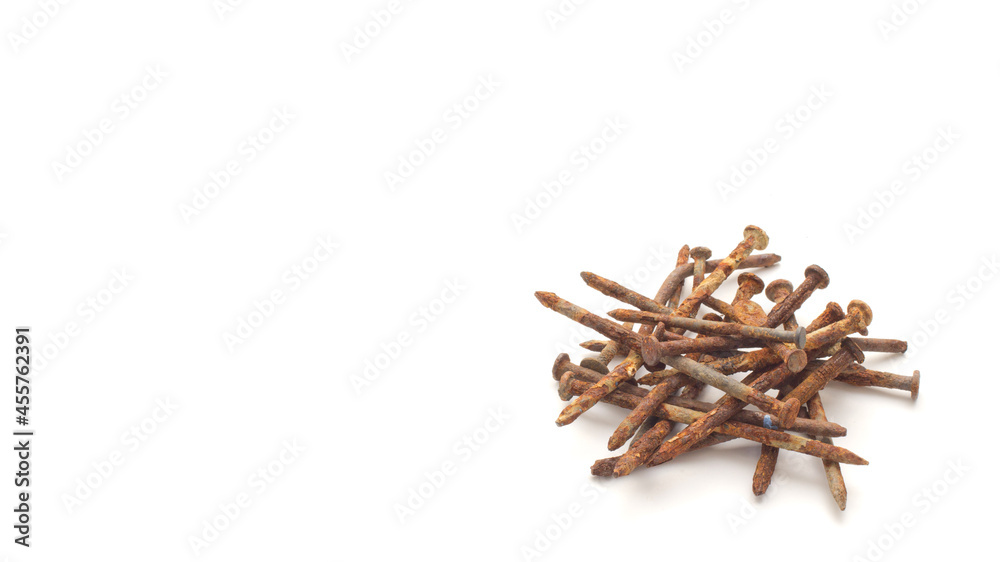 Pile of old and rusty construction carpentry nails on white