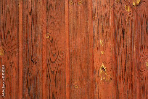 A wall of painted wooden boards as a background.