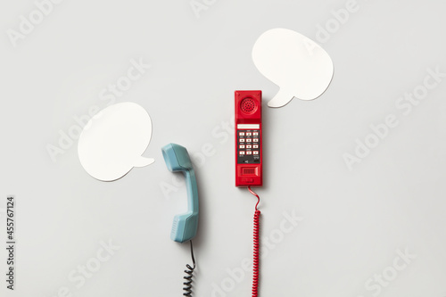 Telephone handsets and speech bubbles