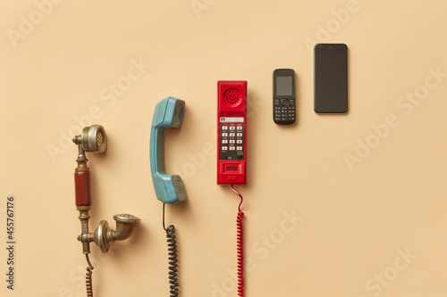 Old telephone handsets and mobile phones photo