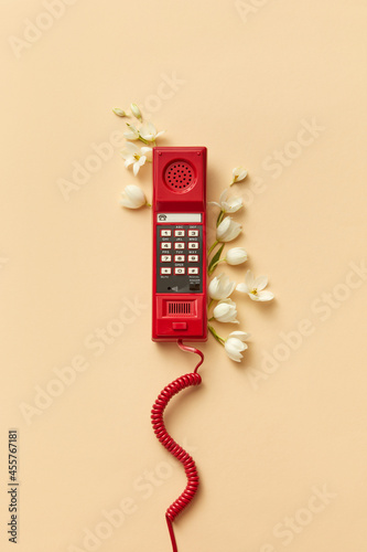 Red telephone handset with flowers